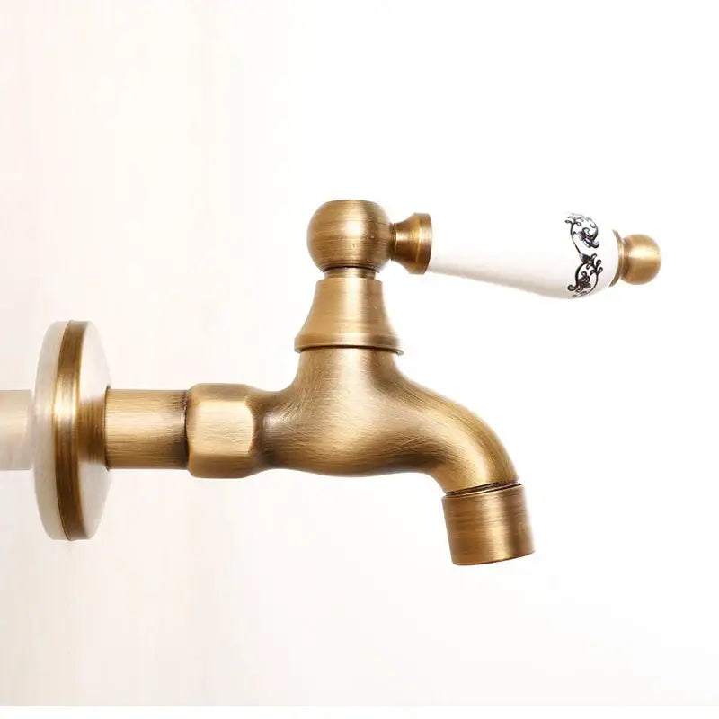 Antique brass bibcock faucet with white ceramic handle featuring black floral detailing decorbites brass antique garden tap