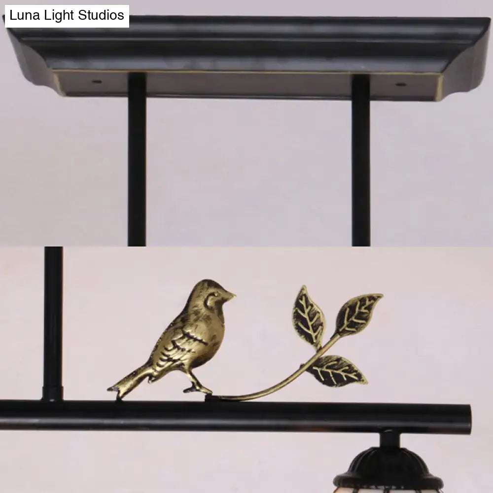 Bronze bird perched on leafy branch detailed metal ornament of antique brass and blue indoor island pendant stained glass shade