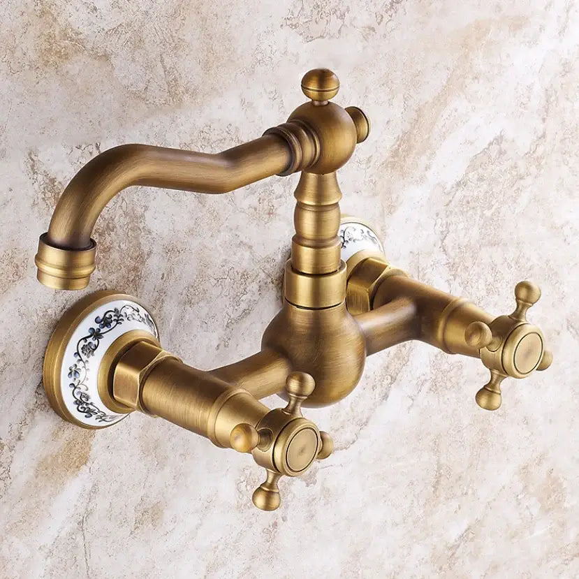 Antique brass ceramic wall mount faucet with dual handles and porcelain knobs featuring black floral decorbites brass ceramic design