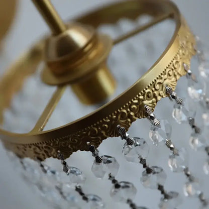 Antique brass crystal led wall sconce with gold-toned ornate scrollwork and dangling clear crystal beads decorbites crystal led