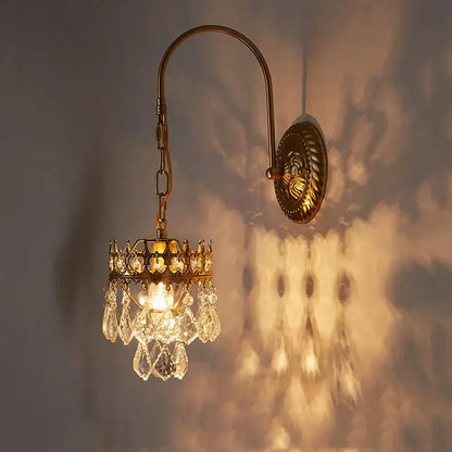 Antique brass crystal wall lamp with dangling crystal droplets and crown top for luxury bedroom decorbites wall lamp