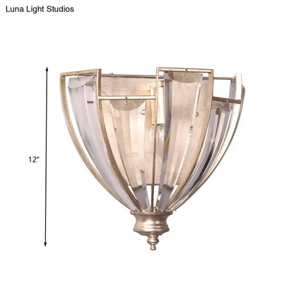 Antique brass curved wall sconce with brushed nickel finish and clear ribbed glass panels for bedroom use