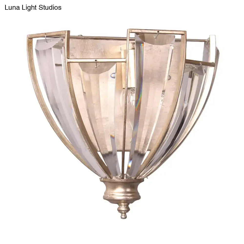 Antique brass curved wall sconce with brushed brass frame and ribbed clear glass panels for bedroom use