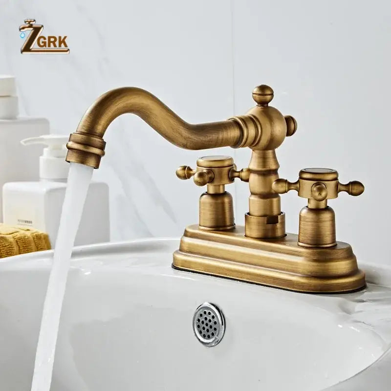 Antique brass deck mounted double handle basin sink faucet with housing material brass and a curved spout vintage design