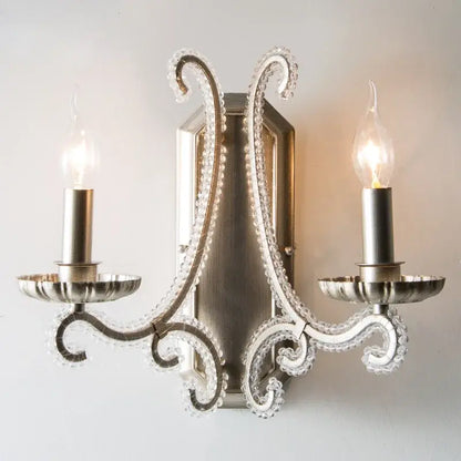 Silver-toned decorbites crystal led wall sconce with ornate crystal-encrusted arms and candle-style bulbs for living room lighting
