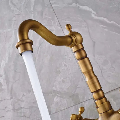 Antique brass dual handle swivel sink faucet with curved spout and ornate segmented handles for kitchen decorbites dual handle