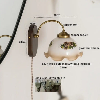 Antique brass floral frosted glass led wall light with brass copper arm and dark wood backplate for bedroom sconce use