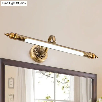 Antique brass finish wall lamp with ornate floral detailing and sleek elongated led bar emitting warm white light