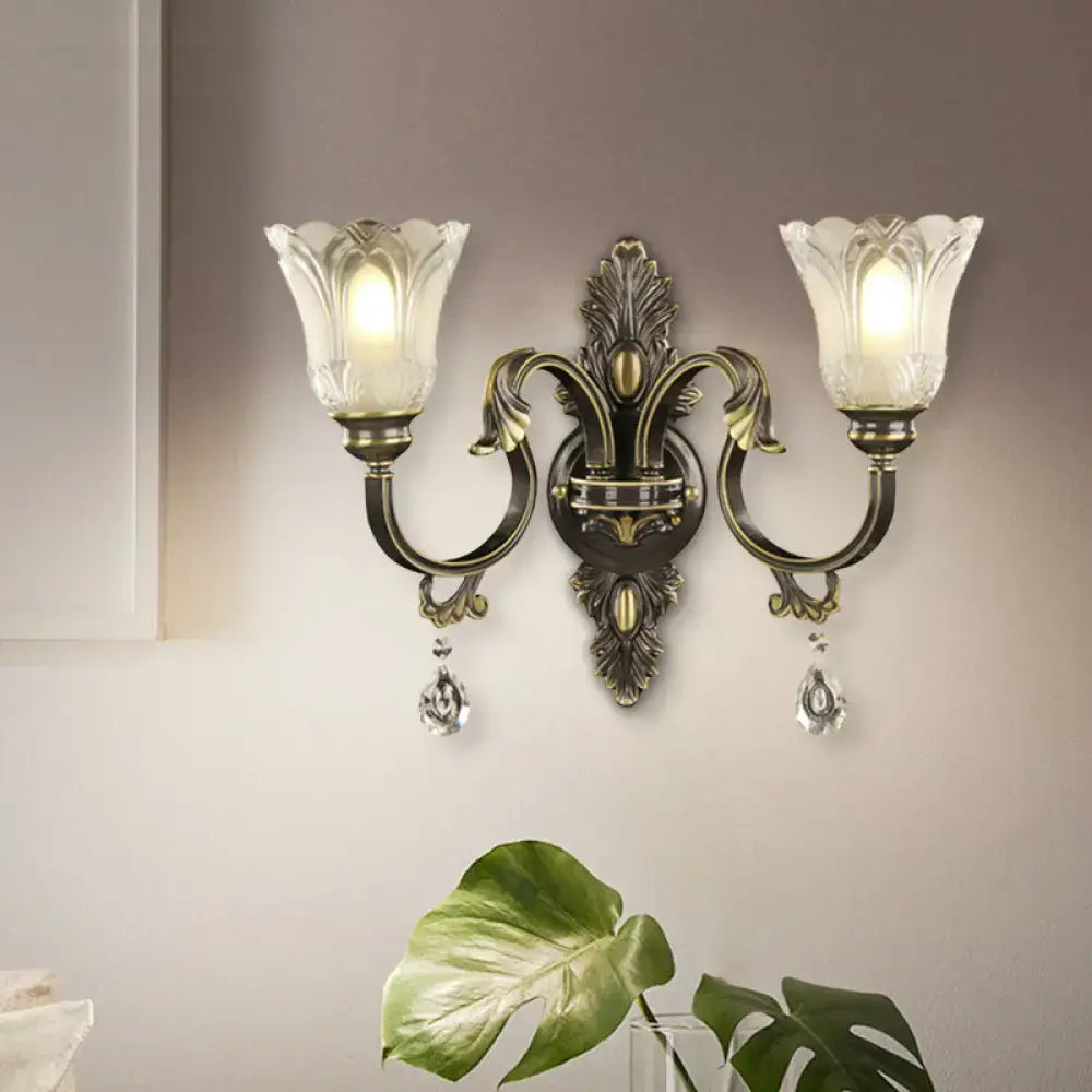 Antique brass floral wall sconce with metal base two-light design frosted glass tulip shades 15 inches tall for bedroom