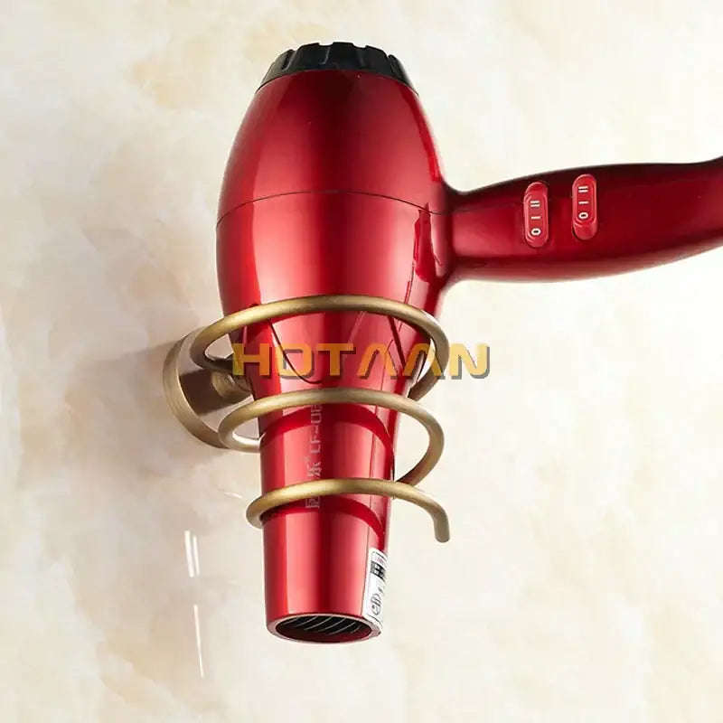 Antique brass hair dryer holder rack with triple loop bathroom shelf holding a red metallic hair dryer with black nozzle