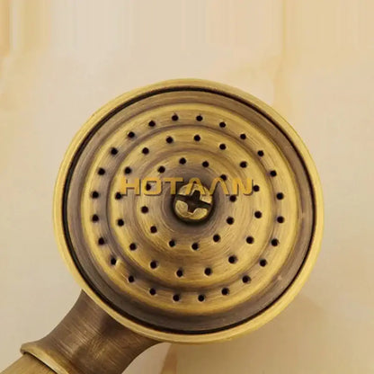 Antique brass hand shower set with brass-finished showerhead featuring concentric circular perforations for bathroom use
