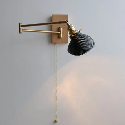 Antique brass industrial wall light with clear glass featuring a sleek black ribbed glass lamp on wooden backplate decorbites clear glass