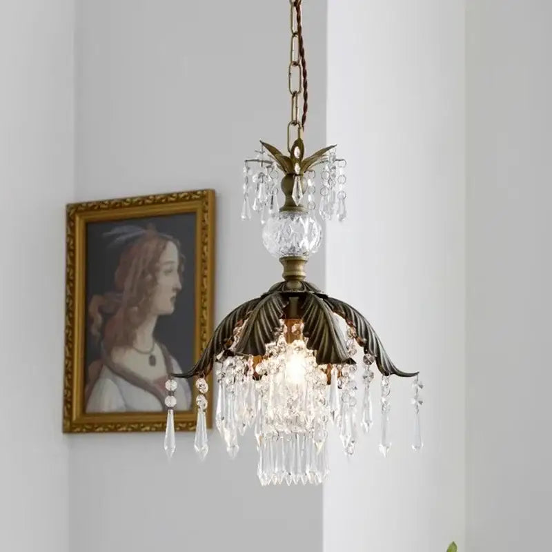Antique brass leaf crystal pendant light featuring dangling crystal droplets and faceted glass orb for bedroom decor