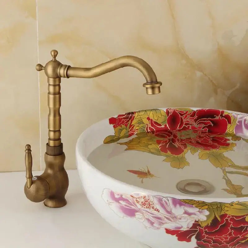 Antique brass ornate decorbites basin sink faucet with single-handle curved spout and ridged stem design