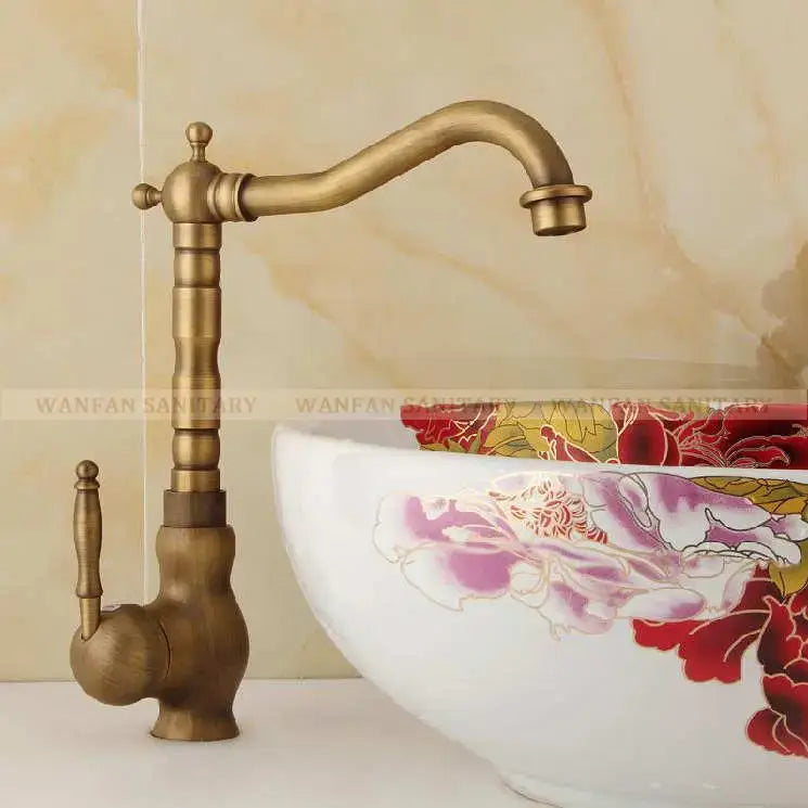 Antique brass ornate decorbites basin sink faucet with curved spout and vintage detailing for bathroom use