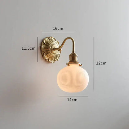 Antique brass wall lamp with ribbed frosted glass globe featuring decorbites frosted glass for elegant bedroom sconce decor