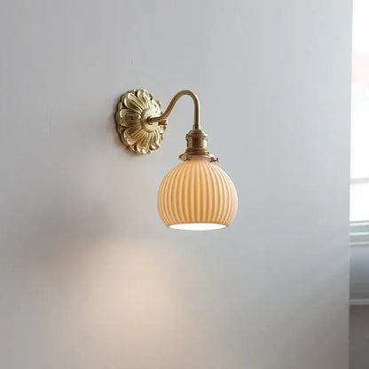 Antique brass wall lights with ribbed cream-colored glass shade featuring decorbites ceramic ball led design for bedroom use
