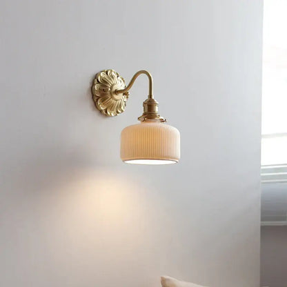 Antique brass wall lights with a fluted cream-colored ribbed glass shade for elegant bedroom decorbites ceramic ball led