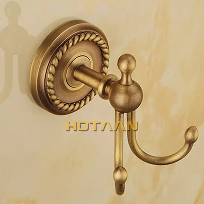 Antique brass double hook towel rack with rope twist backplate and spherical finials in decorbites brass bathroom set