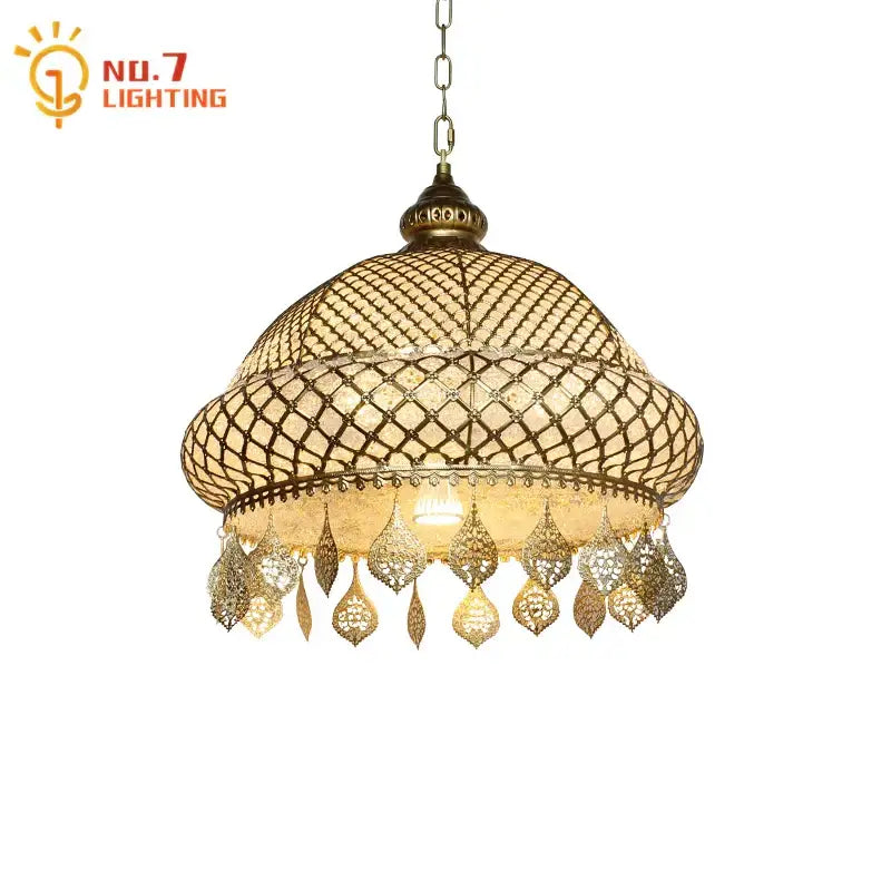 Antique brass pendant lights with intricate woven mesh and dangling teardrop charms in decorbites gold lustre iron style