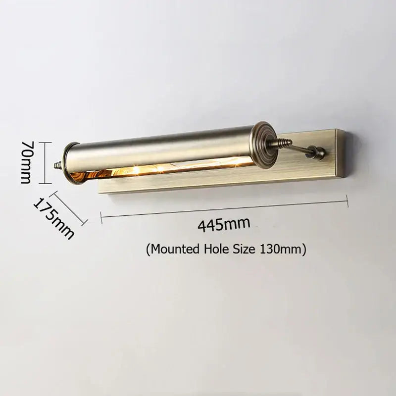 A sleek brushed brass cylindrical antique bronze bathroom wall lamp with adjustable arm and warm glass vanity light