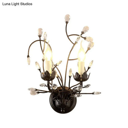 Elegant black wrought iron wall light with crystal accents and two candle-style bulbs for living room use