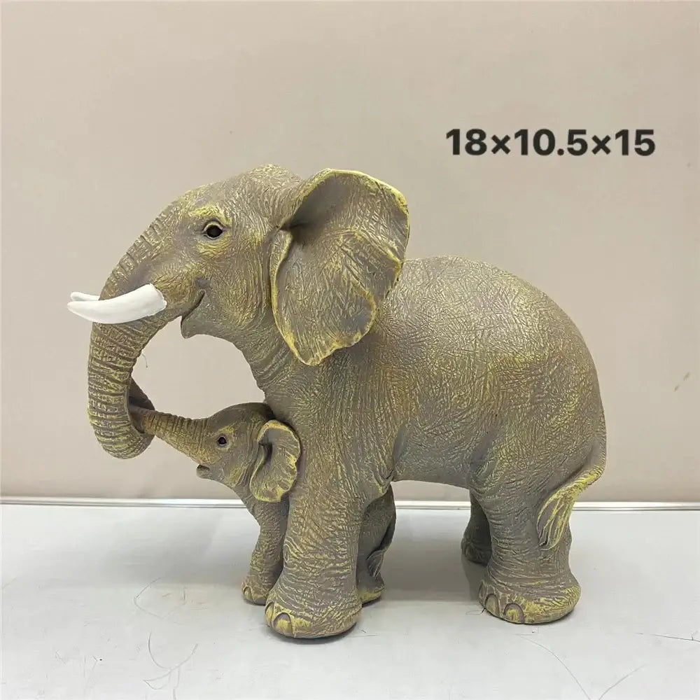 Antique bronze gray and gold elephant family figurine with textured skin and white tusks for living room decor