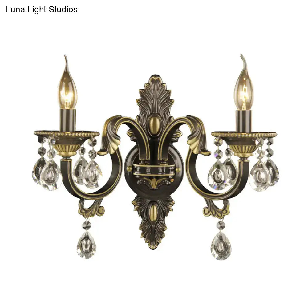 Antique bronze and gold nordic wall mount light with brass and crystal two-light sconce featuring ornate leaf motifs