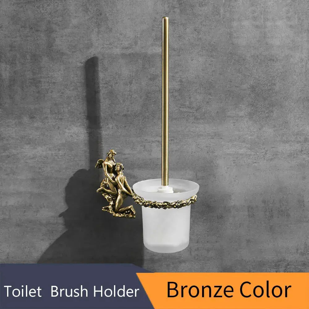 Bronze-colored toilet brush holder with frosted glass base and ornate cherub figure for elegant bathroom use