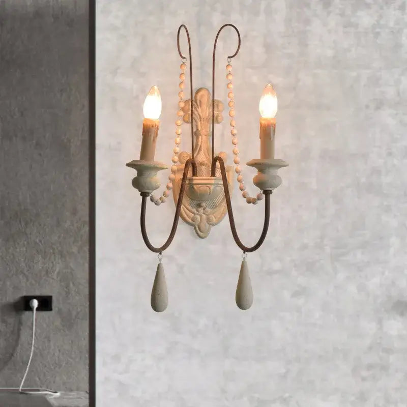 Antique country french wall lamp with distressed white bronze finish ornate scrollwork and teardrop stone pendants decorbites country french wall