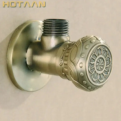 Antique engraved brass triangle valve bathroom faucet with ornate floral and scrollwork brass triangle handle detailing