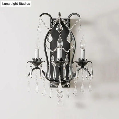 Elegant black wrought iron candelabra wall light with cascading clear crystal droplets for dining room decor
