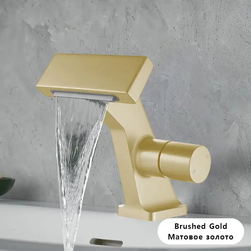 Brushed gold single hole waterfall bathroom faucet with modern angular design and anti-splash spout in antique gold