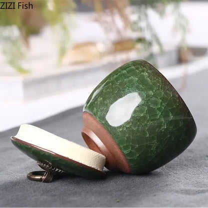 Antique green ceramic tea caddy with ice cracked texture and copper-toned rim for kitchen storage use