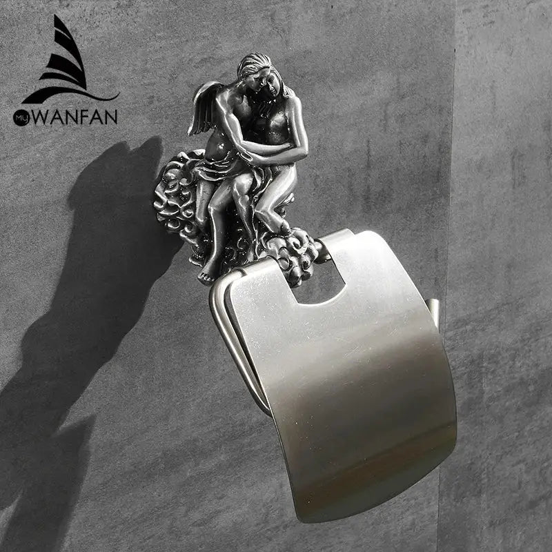 Silver-toned toilet paper holder with ornate angel and cherub sculpture on a sleek metal base for bathroom decor