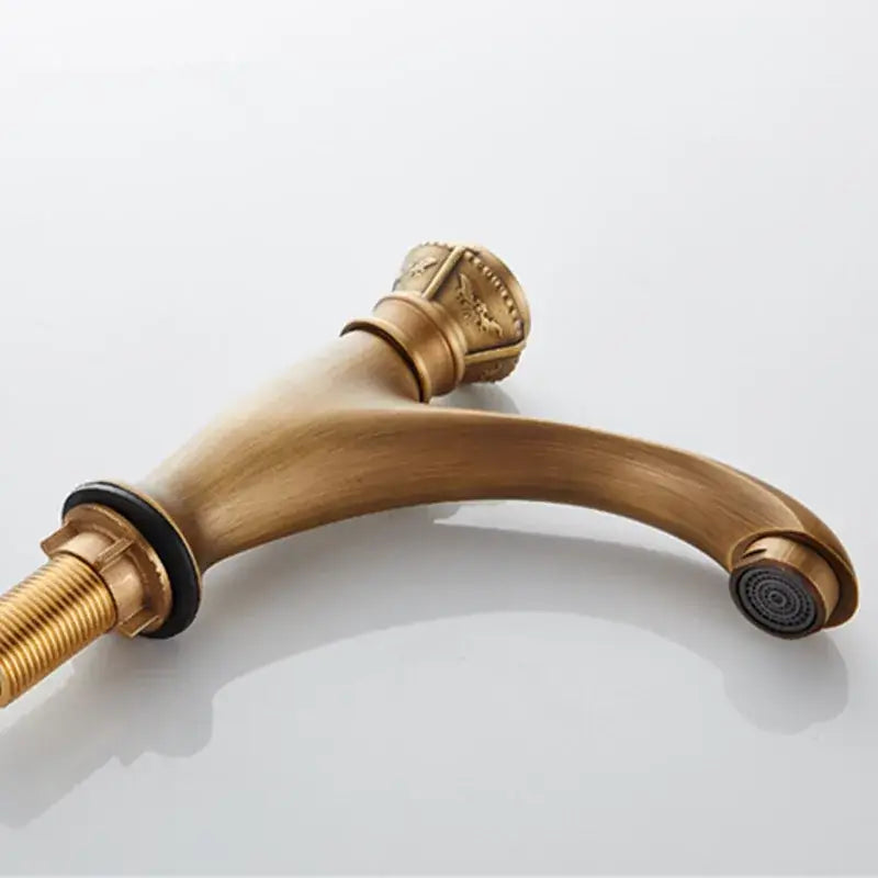 Antique ornate brushed bronze basin faucet with single lever tap and curved spout in decorbites brushed bronze finish