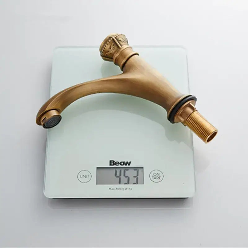 Antique ornate brushed bronze basin faucet with single lever tap and crown handle in decorbites brushed bronze finish