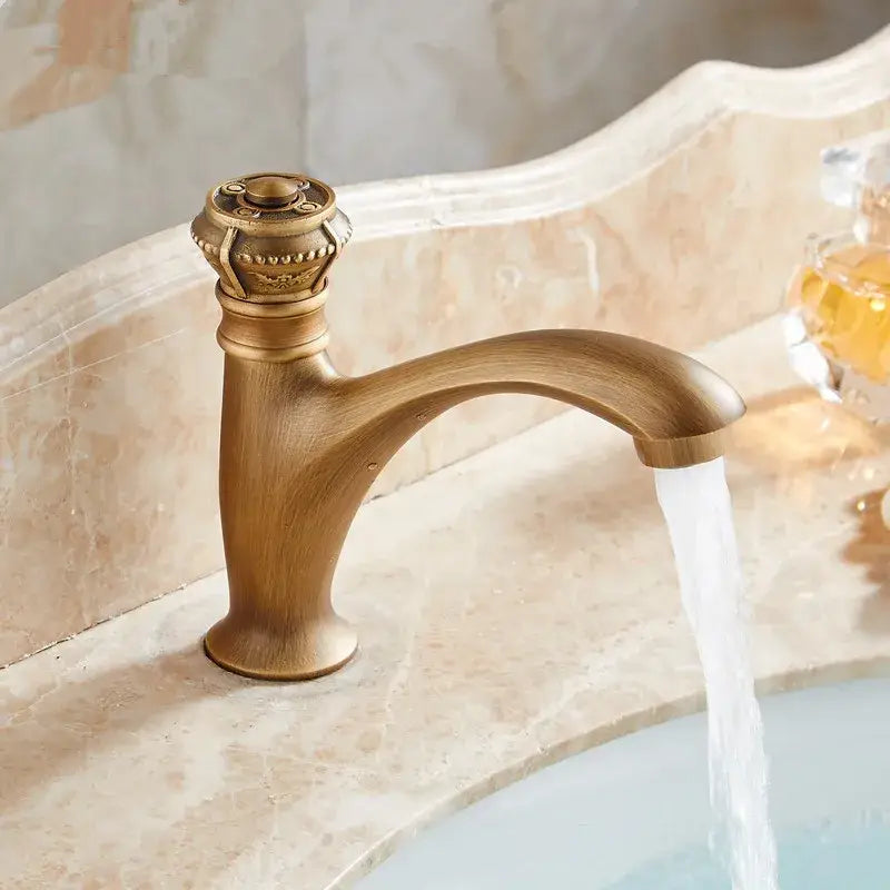 Antique ornate brushed bronze basin faucet with single lever tap and ornate crown knob in decorbites brushed bronze finish