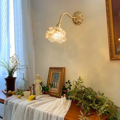 Antique pink rose glass wall lamp with a delicate gold-toned decorbites copper arm and flower-shaped shade
