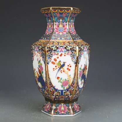 An ornate octagonal porcelain vase with vibrant hand-painted birds and flowers accented with gold trim from a porcelain vase collection