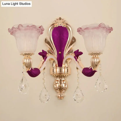 Elegant antique purple and gold double head mount light fixture with frosted pink glass shades and crystal accents