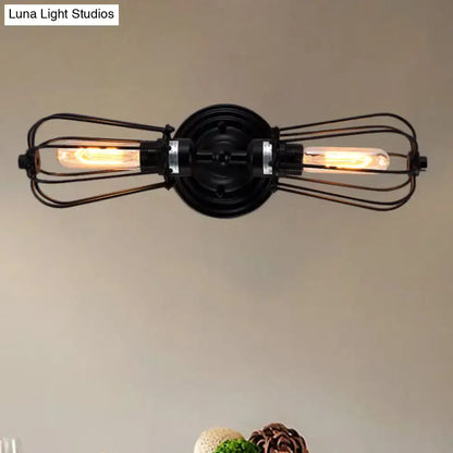 Antique style black bronze sconce light featuring industrial wrought iron with two exposed filament bulbs for dining room
