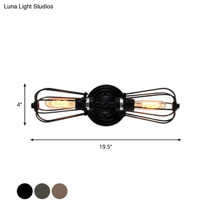 Antique style black bronze wrought iron sconce light with two exposed filament bulbs in wire cages for dining room
