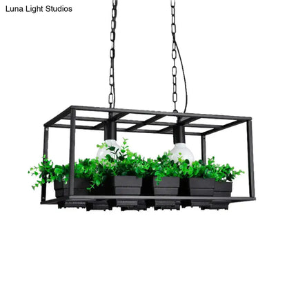 Black metal rectangular island lamp with two white bulbs, hanging ceiling light with green potted plants inside frame