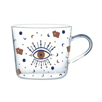 Clear 500ml glass mug with apricot and orange pattern featuring central eye and celestial motifs in navy blue and copper