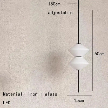 A modern art deco pendant light with white glass and a sleek black iron frame for dining room use
