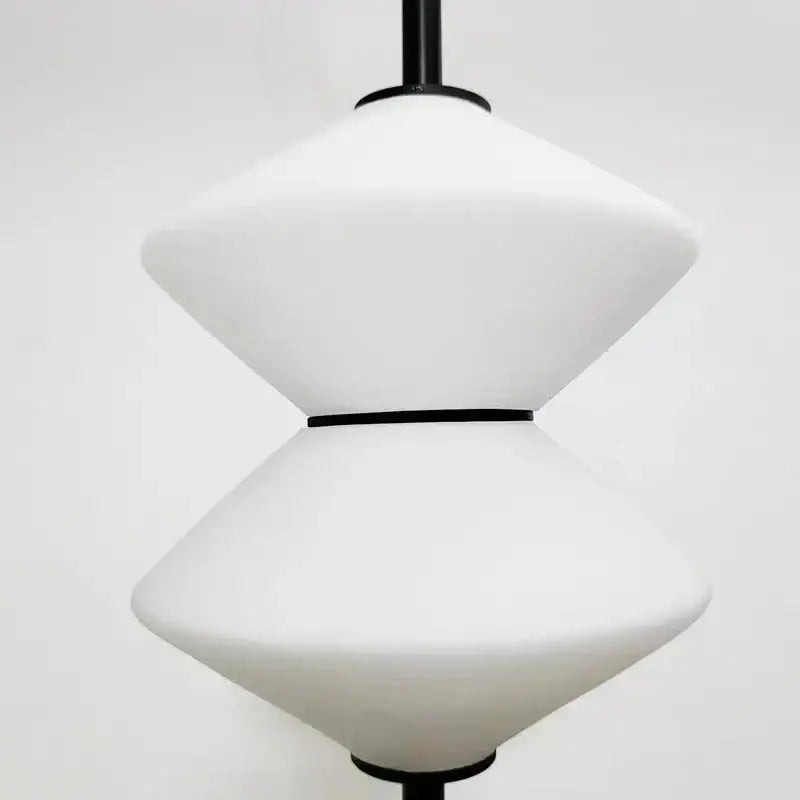 Art deco black and white glass pendant light with modern white opal glass and black metal accents for dining room