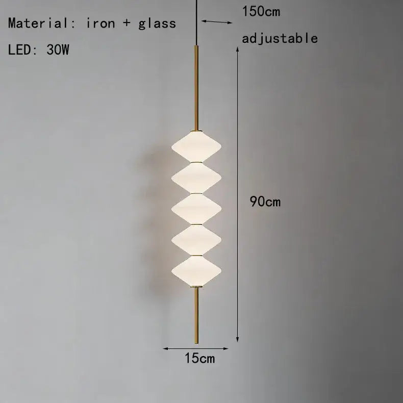 A modern art deco pendant light with five stacked white glass diamond-shaped shades on a brass iron rod