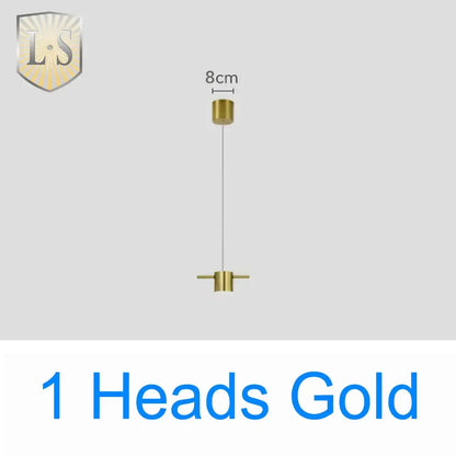 Gold-colored art deco pendant light with sleek cylindrical fixtures connected by thin cord ideal for dining room light sources