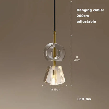 A modern minimalist art deco brass crystal led ceiling chandelier with clear faceted crystal shade and gold accents